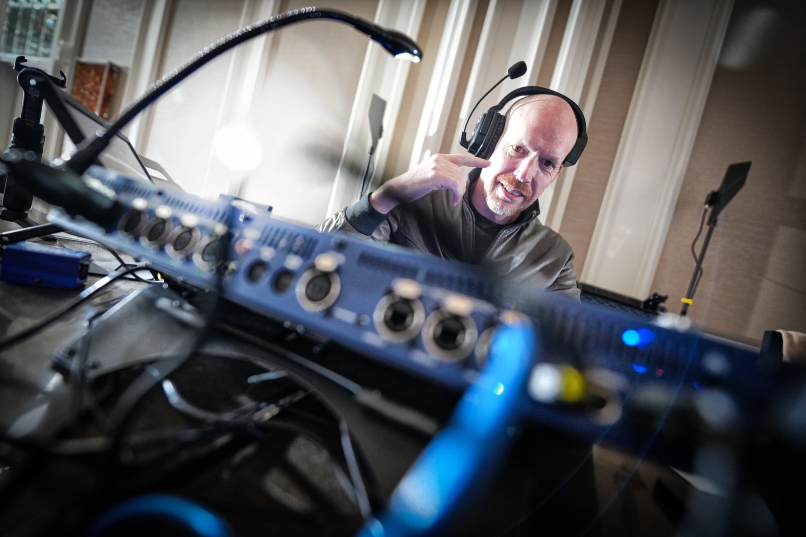 Ralph Vieberink at the production desk, wearing a headset.